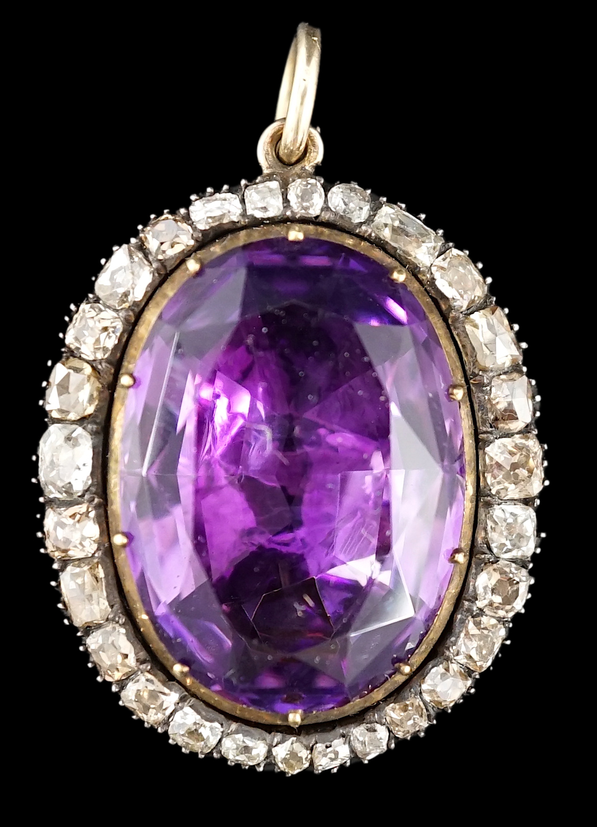 An early 19th century, gold and oval cut foil backed amethyst set pendant, with old cut diamond set border and closed back setting